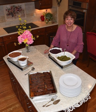 Ursula ready to open the Buffet of Beef Ribs, Rice, Gravy, Red Cabbage and Green Beans